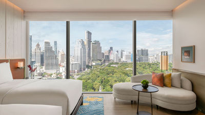 A guestroom overlooking Lumphini Park at the Andaz One Bangkok.
