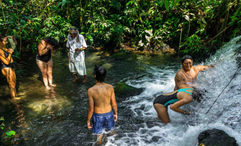 Sumpa, a shaman elder from the village of Wachirpas, conducts a cleansing ritual for a family at a hidden waterfall.