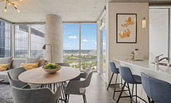 A living and dining area in an Apartment Collection by Hilton furnished apartment.