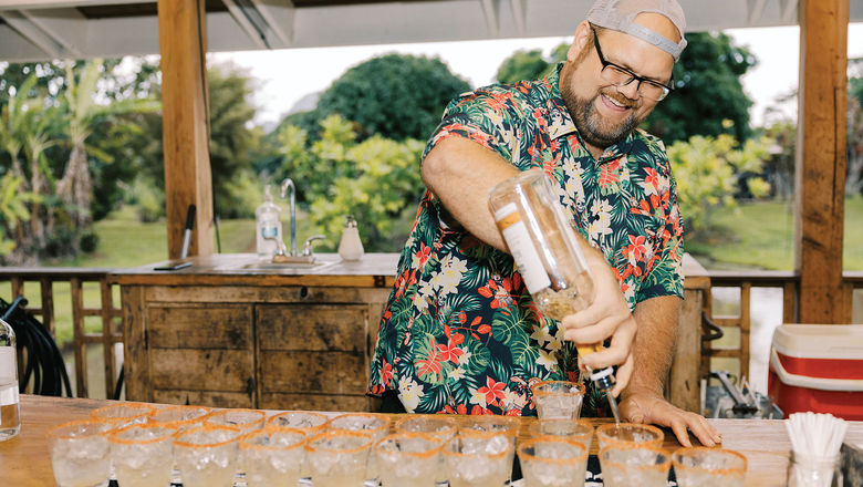 A bartender prepares a round of mai tais for guests taking the Kauai Rum Safari Tour at Kilohana Plantation.