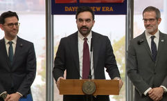 New York City mayor Zohran Mamdani (center) announcing the city's new regulations requiring hotel fee transparency.