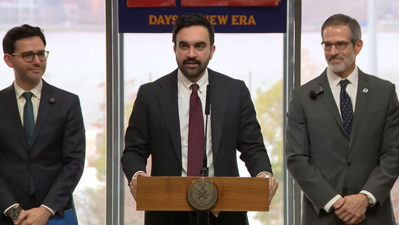 New York City mayor Zohran Mamdani (center) announcing the city's new regulations requiring hotel fee transparency.