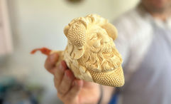 Sinan Onalci holding a meerschaum pipe with the face of the Greek god Dionysus.