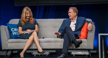 Vicki Freed, Royal Caribbean's senior vice president of sales and trade support and services, on stage at CruiseWorld with Royal Caribbean Group chairman Richard Fain.