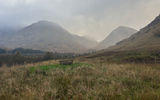 The mist rises over Glen Coe in the Scottish Highlands.