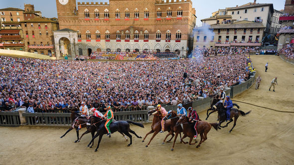 The Palio di Siena horse race on the Main Square in Siena, Italy. Red Savannah packages travel around the event.