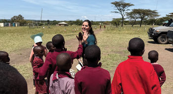 Sandra Solis, Abercrombie & Kent Philanthropy’s (AKP) coordinator in Peru, high-fives students in Kenya’s Masai Mara.